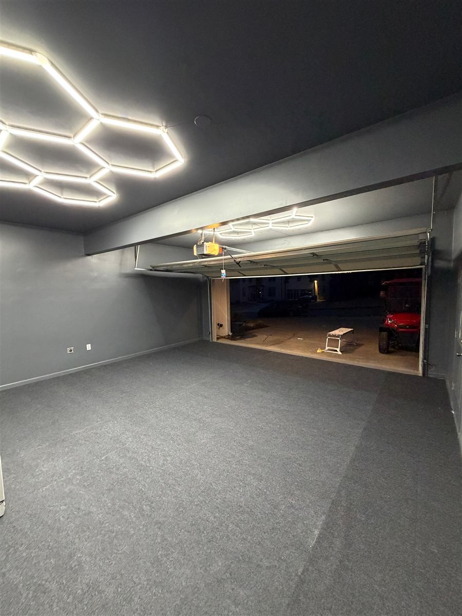 Finished garage conversion with smooth grey walls and LED lighting