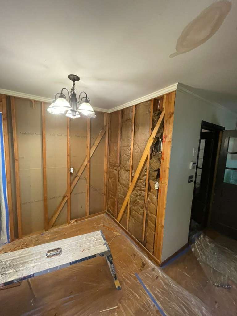 Living room stripped to studs before drywall installation
