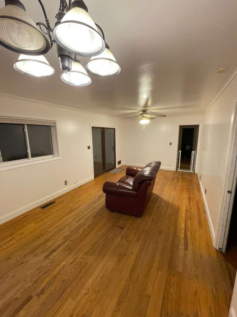 Wide view of the completed living room after wall restoration
